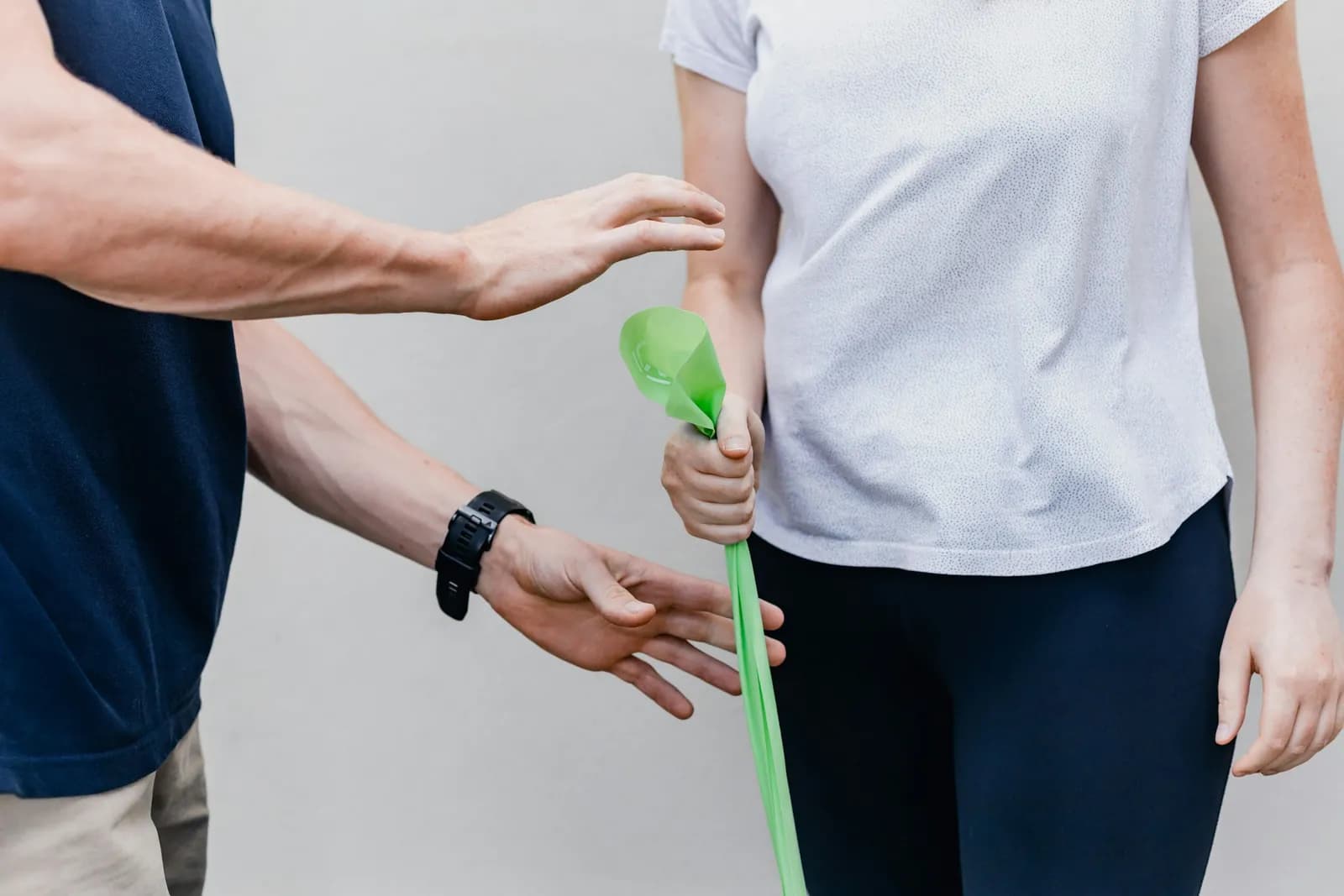 Patient doing a resistance band exercise with a clinician's guidance