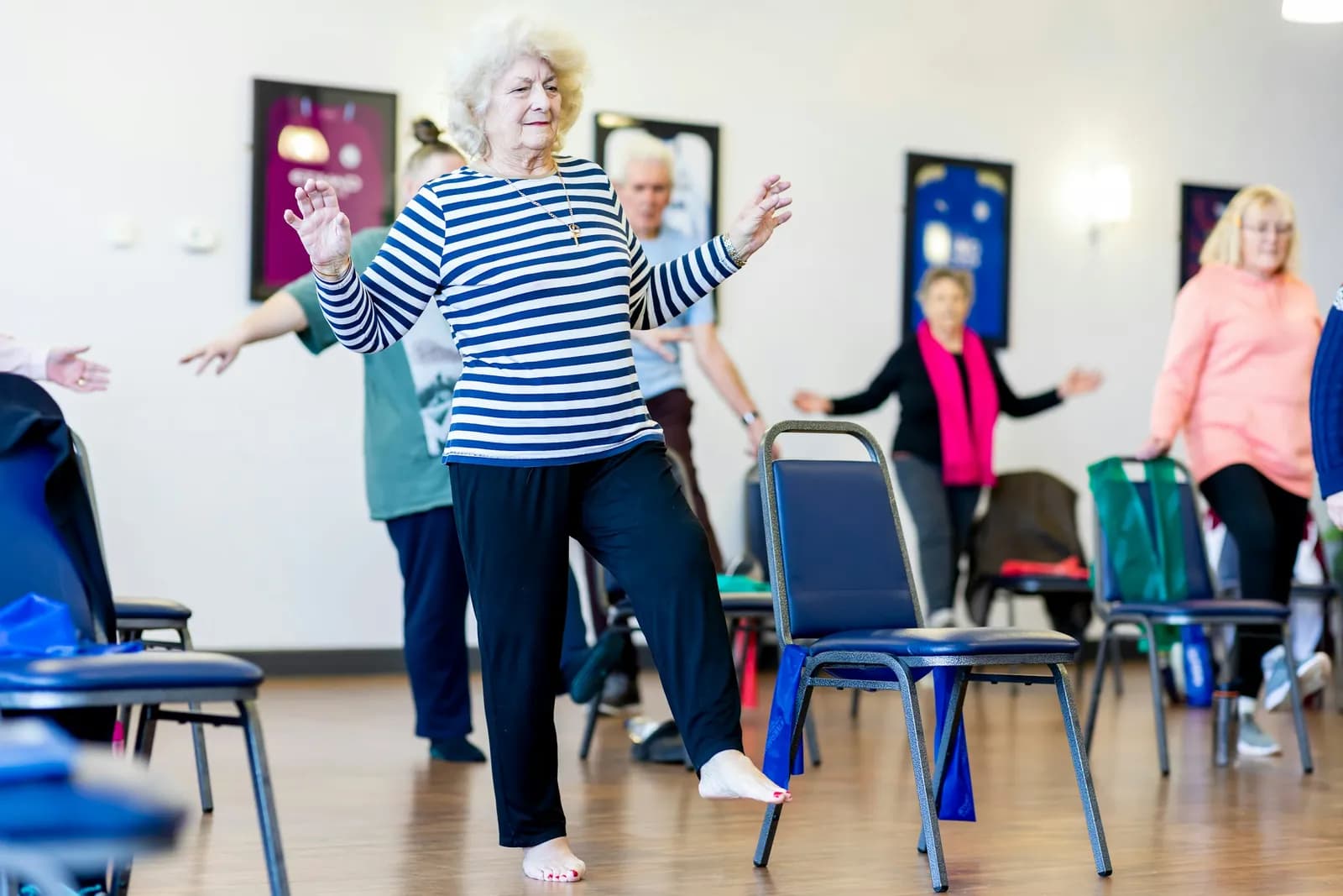 Group of older women exercising together in a hall