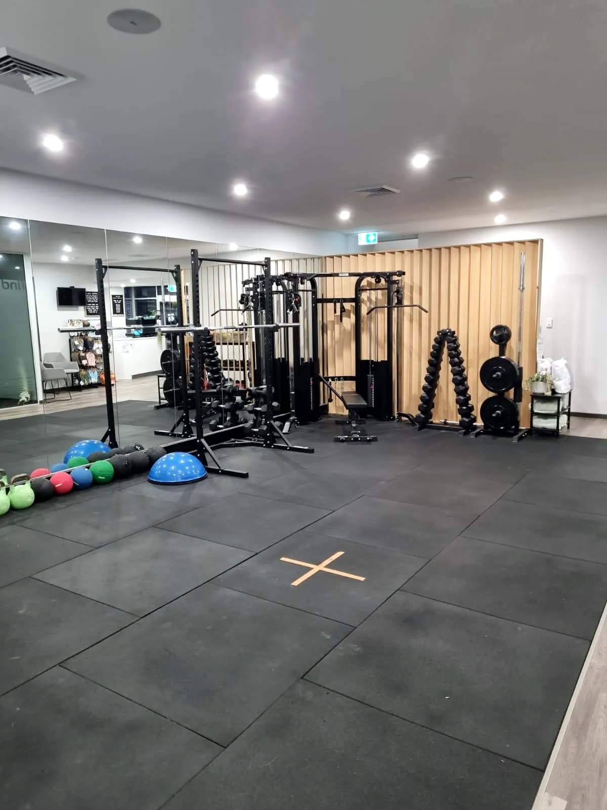 Strength equipment and kettlebells on the gym floor at Concord West