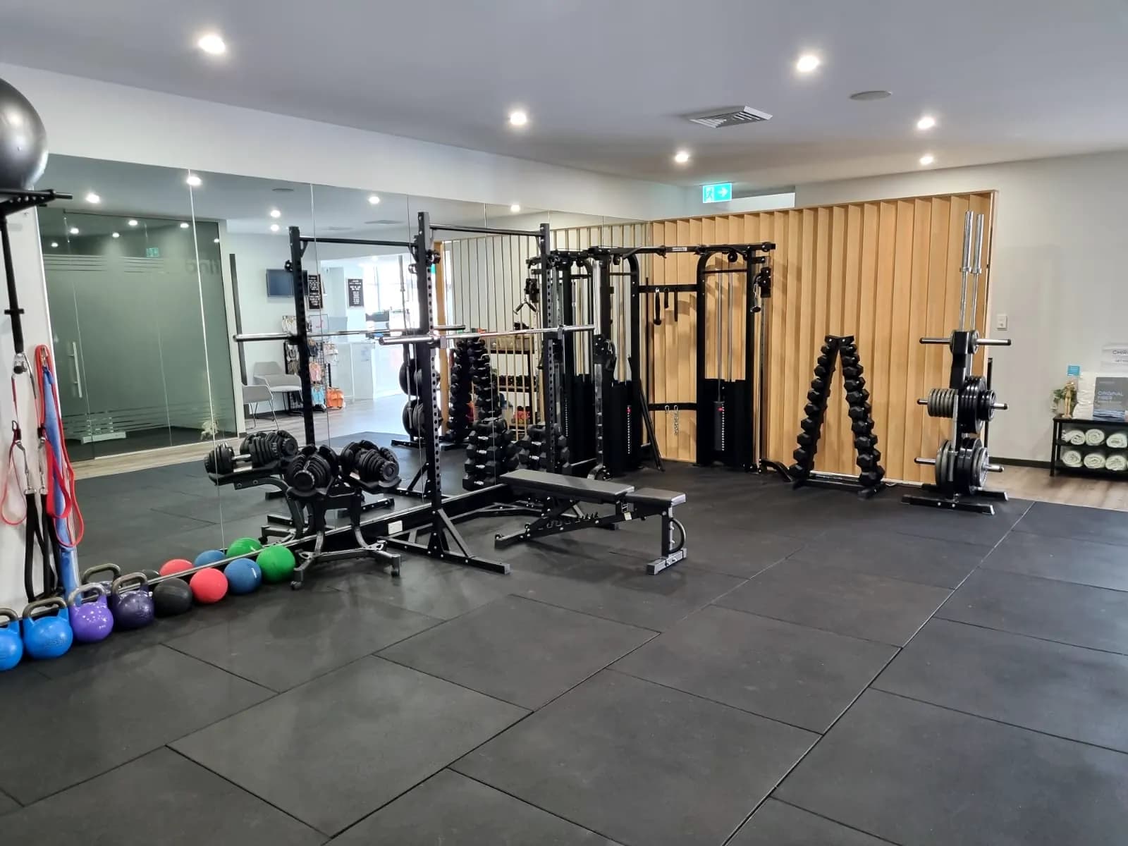 The exercise floor at Concord West, with squat racks, dumbbells and kettlebells