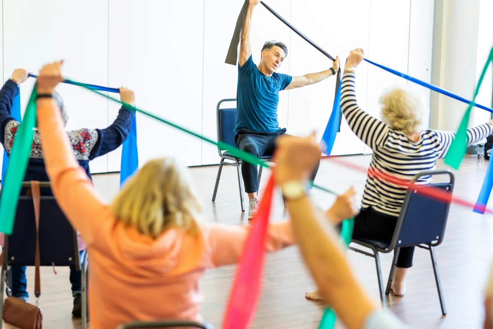Group of older adults exercising with resistance bands