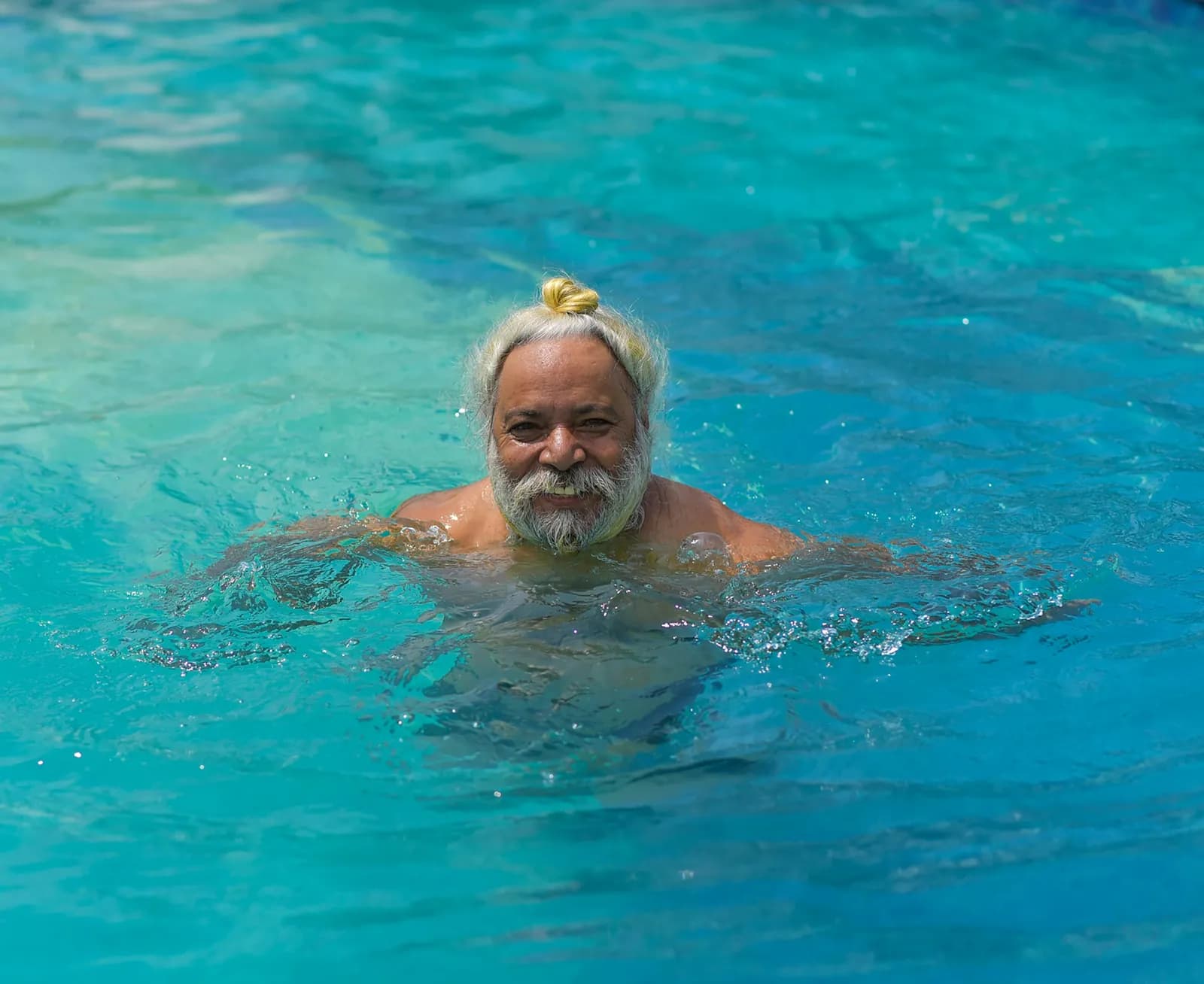 Smiling older man exercising in a swimming pool