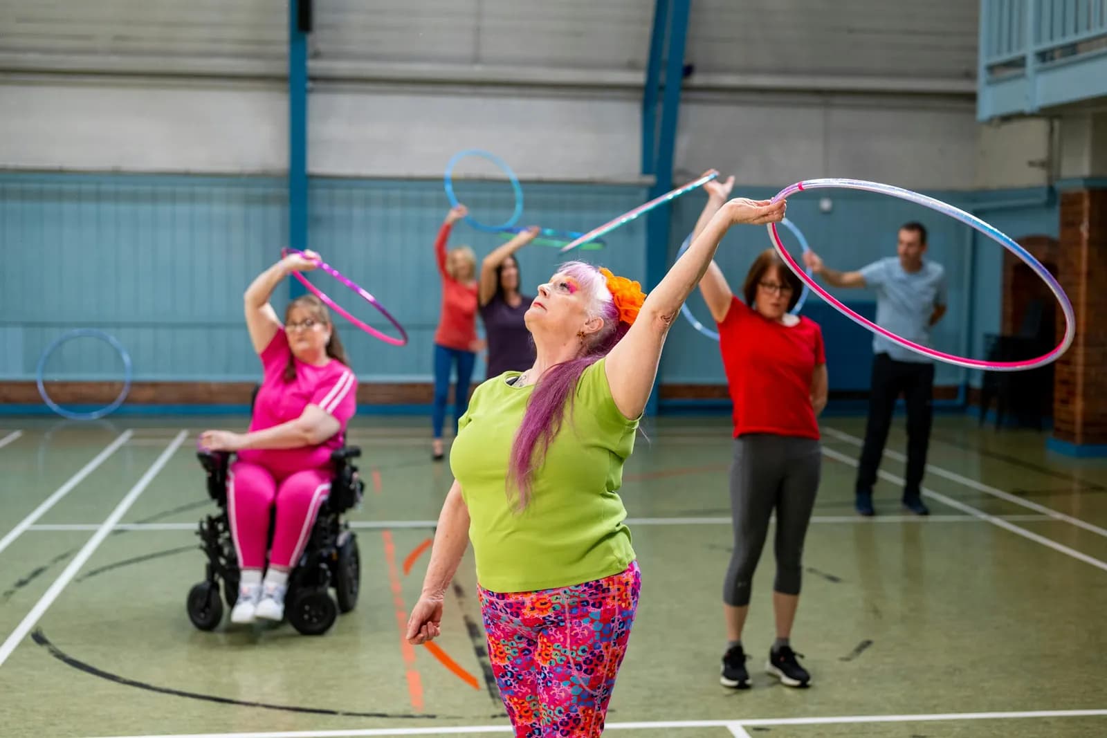 People of different abilities exercising together in a sports hall