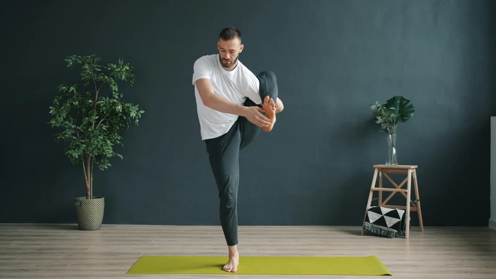 Man practising single-leg balance at home
