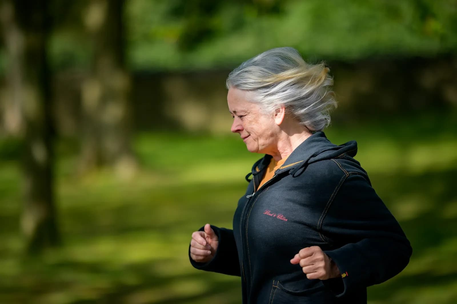 Older woman jogging in a park