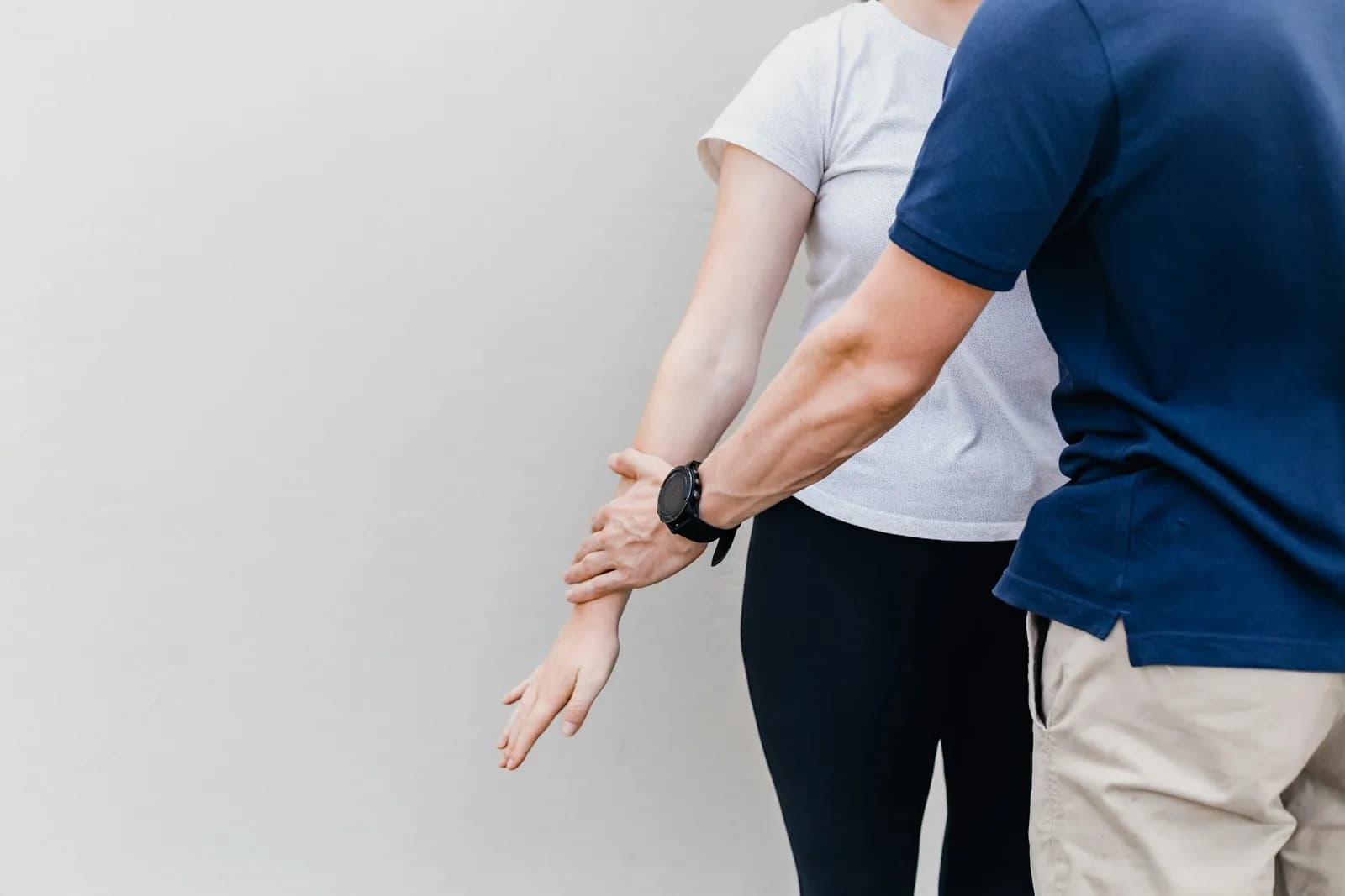 Clinician guiding a patient's arm movement