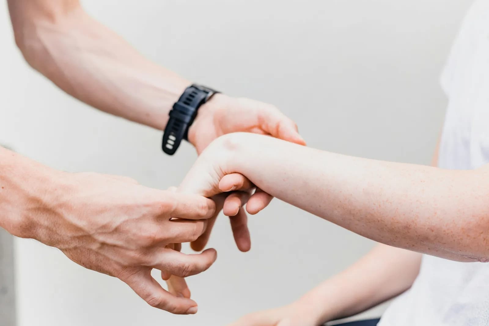 Clinician supporting a patient's hand and wrist
