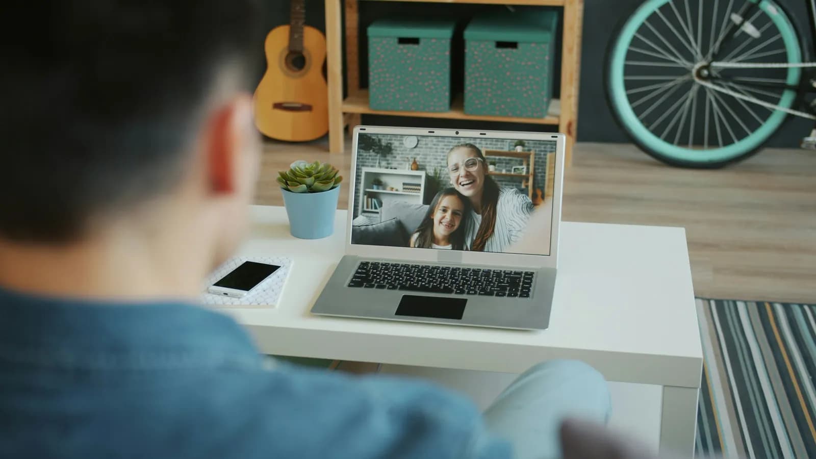 Man on a video call on his laptop at home