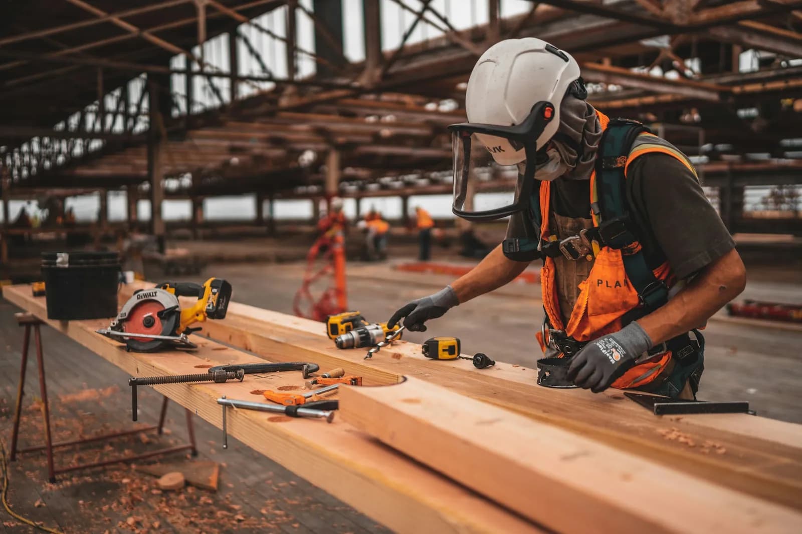 Construction worker in a hard hat and hi-vis vest on site